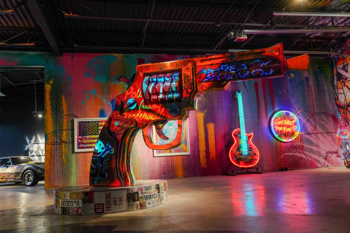 An immersive Gallery DeFi room with a neon guitar, an arcade installation and work by participating artists.