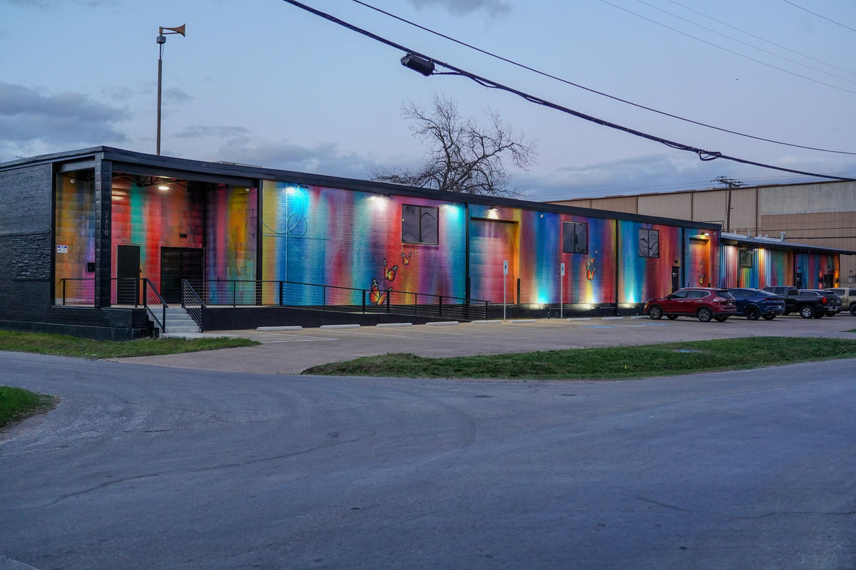 Gallery DeFi's painted exterior at dusk, at 2200 Evanston Avenue in West Dallas.