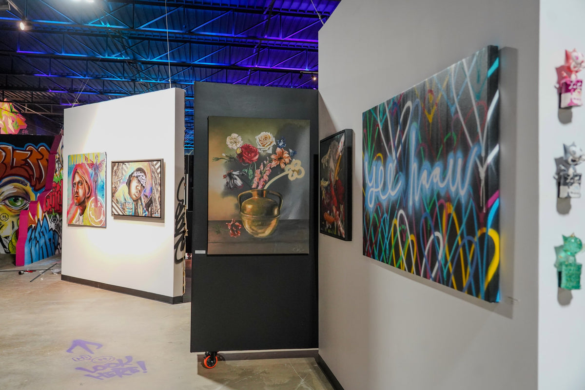 A view through Gallery DeFi's artwork-lined rooms, with paintings and sculpture by participating artists.